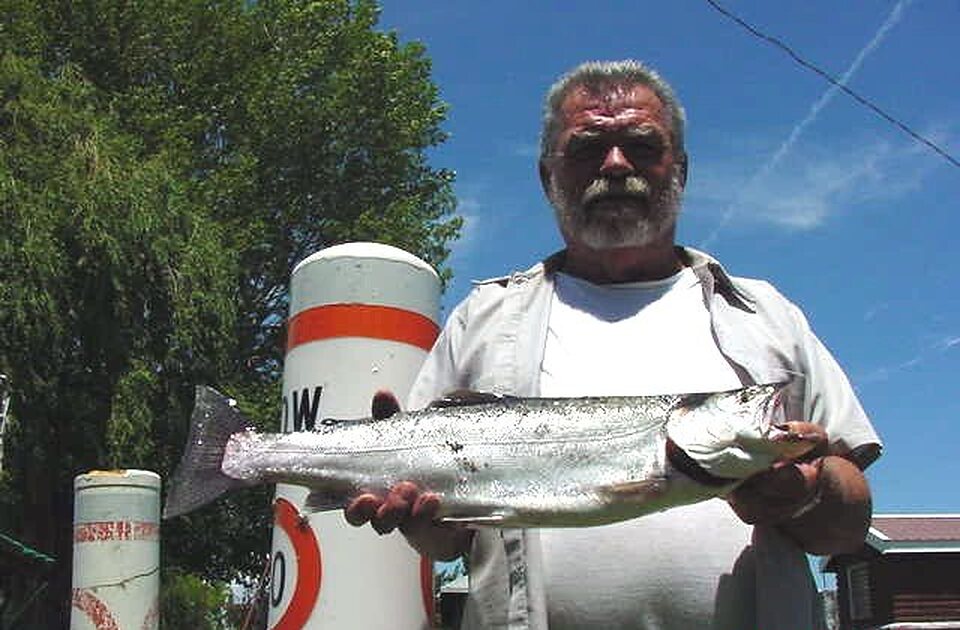 Angler holding a heavy trout with both hands